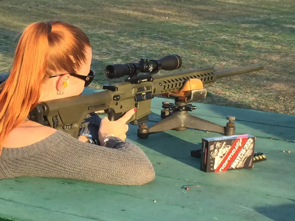Woman aiming a gun